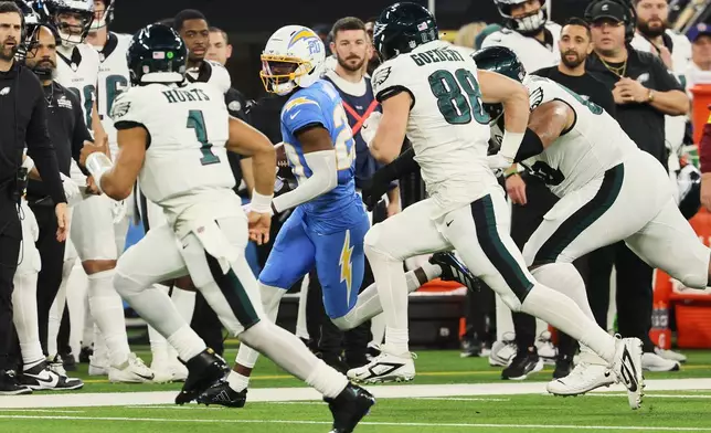 Los Angeles Chargers cornerback Cam Hart (20) runs back with an intercepted pass during the second half of an NFL football game against the Philadelphia Eagles, Monday, Dec. 8, 2025, in Inglewood, Calif. (AP Photo/Kevork Djansezian)