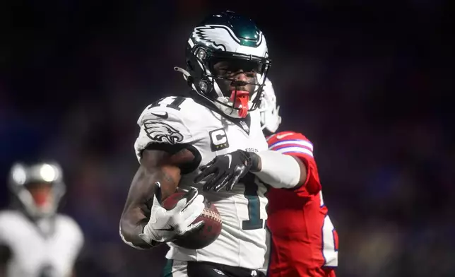 Philadelphia Eagles' A.J. Brown, left, cannot hang onto a pass against Buffalo Bills cornerback Tre'Davious White during the first half of an NFL football game, Sunday, Dec. 28, 2025, in Buffalo, N.Y. (AP Photo/Adrian Kraus)