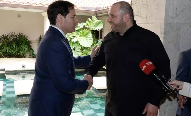 FILE - U.S. Secretary of State Marco Rubio, left, and Ukraine's Secretary of National Security Rustem Umerov shake hands, on Nov. 30, 2025, in Hallandale Beach, Fla. (AP Photo/Terry Renna, File)