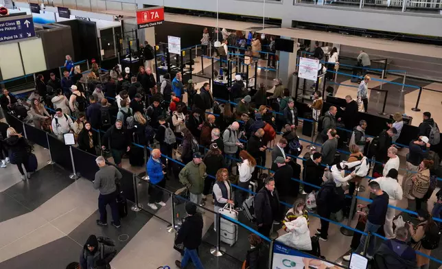 FILE - People wait in security lines at O'Hare International Airport, Nov. 10, 2025, in Chicago. (AP Photo/Erin Hooley, File)