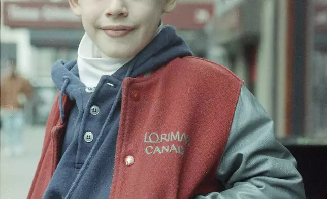 FILE - Macaulay Culkin, star of the movie "Home Alone," stands for a portrait in New York, Jan. 5, 1991. (AP Photo/Malcolm Clarke, File)