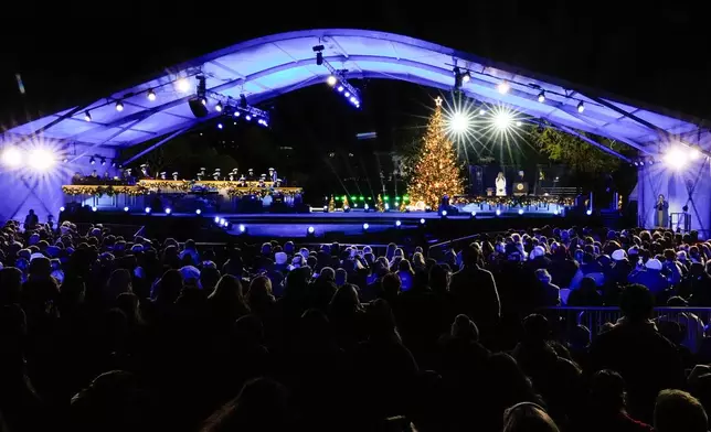 President Donald Trump, accompanied by first lady Melania Trump, speaks following the lighting of the National Christmas Tree on the Ellipse, Thursday, Dec. 4, 2025, near the White House in Washington. (AP Photo/Julia Demaree Nikhinson)
