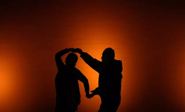 Residents enjoy a social dance during a night winter season at a public park, in Beijing, China, Tuesday, Dec. 16, 2025. (AP Photo/Andy Wong)
