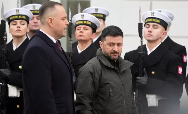 Polish President Karol Nawrocki, left, and Ukrainian President Volodymyr Zelenskyy attend an official welcome ceremony before their meeting at the Presidential Palace in Warsaw, Poland, Friday, Dec. 19, 2025. (AP Photo/Czarek Sokolowski)