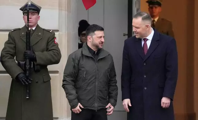 Polish President Karol Nawrocki, right, and Ukrainian President Volodymyr Zelenskyy attend an official welcome ceremony before their meeting at the Presidential Palace in Warsaw, Poland, Friday, Dec. 19, 2025. (AP Photo/Czarek Sokolowski)