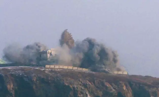 In this photo provided by the North Korean government, smoke billows from a building after it says a long-range strategic cruise missile fired from the Yellow Sea off North Korea hit Sunday, Dec. 28, 2025. Independent journalists were not given access to cover the event depicted in this image distributed by the North Korean government. The content of this image is as provided and cannot be independently verified. Korean language watermark on image as provided by source reads: "KCNA" which is the abbreviation for Korean Central News Agency. (Korean Central News Agency/Korea News Service via AP)