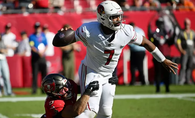 Tampa Bay Buccaneers linebacker SirVocea Dennis (8) forces an intentional grounding by Arizona Cardinals quarterback Jacoby Brissett (7) during the first half of an NFL football game Sunday, Nov. 30, 2025, in Tampa, Fla. (AP Photo/Jason Behnken)