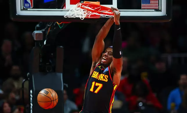 Atlanta Hawks forward Onyeka Okongwu (17) dunks during the first half of an NBA basketball game against the Chicago Bulls, Sunday, Dec. 21, 2025, in Atlanta. (AP Photo/Colin Hubbard)