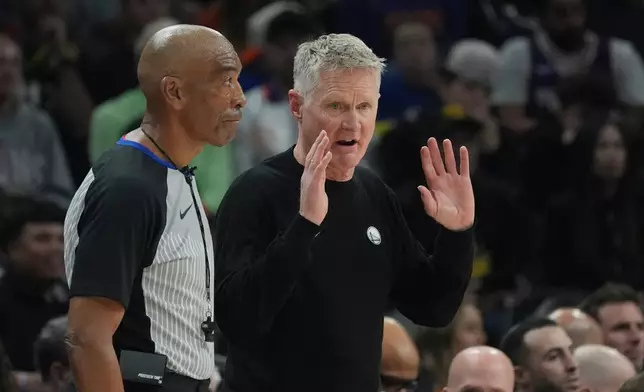 Golden State Warriors head coach Steve Kerr, right, argues with referee Leon Wood, left, during the first half of an NBA basketball game against the Phoenix Suns Thursday, Dec. 18, 2025, in Phoenix. (AP Photo/Ross D. Franklin)