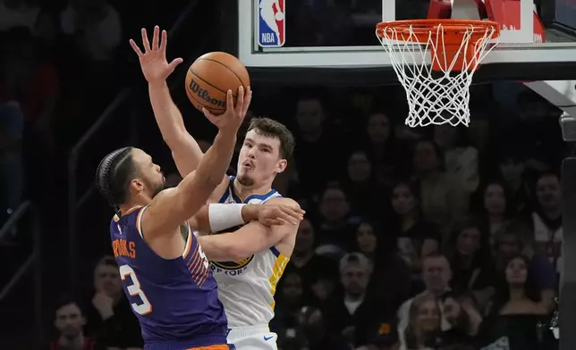 Phoenix Suns forward Dillon Brooks (3) shoots over Golden State Warriors center Quinten Post during the first half of an NBA basketball game Thursday, Dec. 18, 2025, in Phoenix. (AP Photo/Ross D. Franklin)