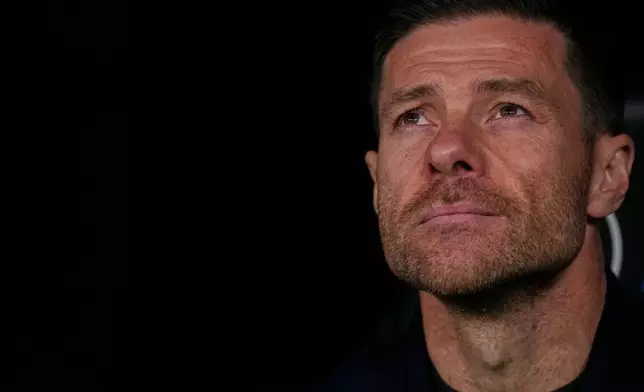 Real Madrid's head coach Xabi Alonso looks out from the dugout ahead of the Spanish La Liga soccer match between Real Madrid and Sevilla in Madrid, Spain, Saturday, Dec. 20, 2025. (AP Photo/Manu Fernandez)