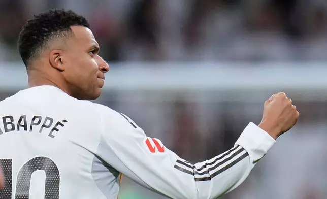 Real Madrid's Kylian Mbappe celebrates after scoring his sides second goal from the penalty spot during the Spanish La Liga soccer match between Real Madrid and Sevilla in Madrid, Spain, Saturday, Dec. 20, 2025. (AP Photo/Manu Fernandez)