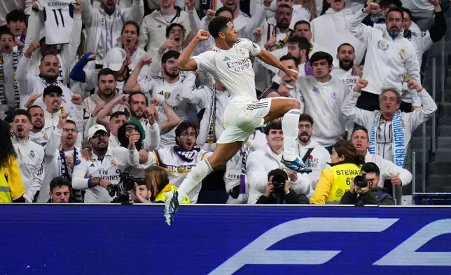 Real Madrid's Jude Bellingham celebrates after scoring the opening goal during the Spanish La Liga soccer match between Real Madrid and Sevilla in Madrid, Spain, Saturday, Dec. 20, 2025. (AP Photo/Manu Fernandez)
