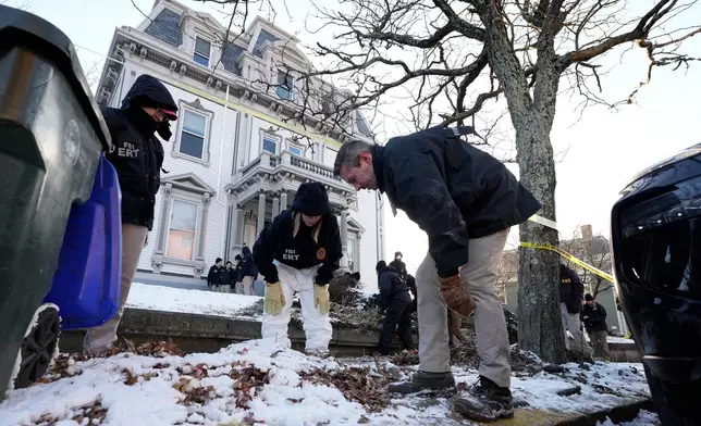 Members of the FBI Evidence Response Team search for evidence near the campus of Brown University, Monday, Dec. 15, 2025, in Providence, R.I. (AP Photo/Robert F. Bukaty)