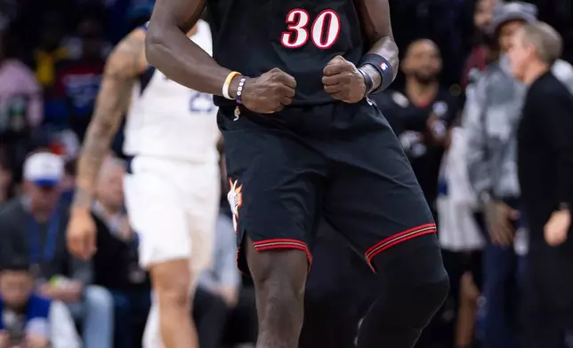 Philadelphia 76ers' Adem Bona reacts after dunking during the first half of an NBA basketball game against the Dallas Mavericks, Saturday, Dec. 20, 2025, in Philadelphia. (AP Photo/Chris Szagola)