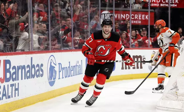 New Jersey Devils left wing Paul Cotter (47) reacts after scoring a goal during the second period of an NHL hockey game against the Anaheim Ducks, Saturday, Dec. 13, 2025, in Newark, N.J. (AP Photo/Adam Hunger)