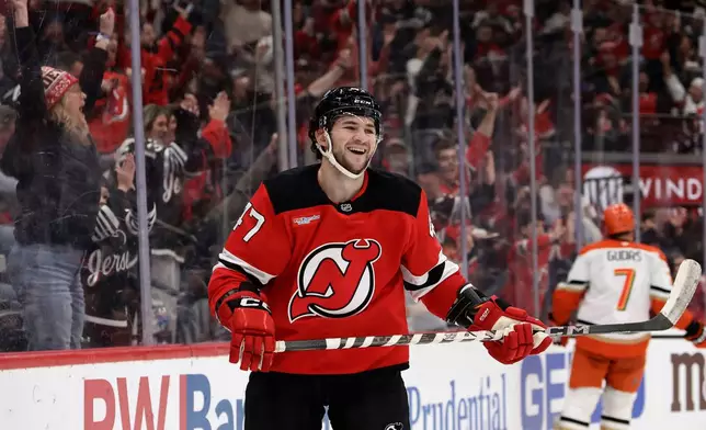 New Jersey Devils left wing Paul Cotter (47) reacts after scoring a goal during the second period of an NHL hockey game against the Anaheim Ducks, Saturday, Dec. 13, 2025, in Newark, N.J. (AP Photo/Adam Hunger)