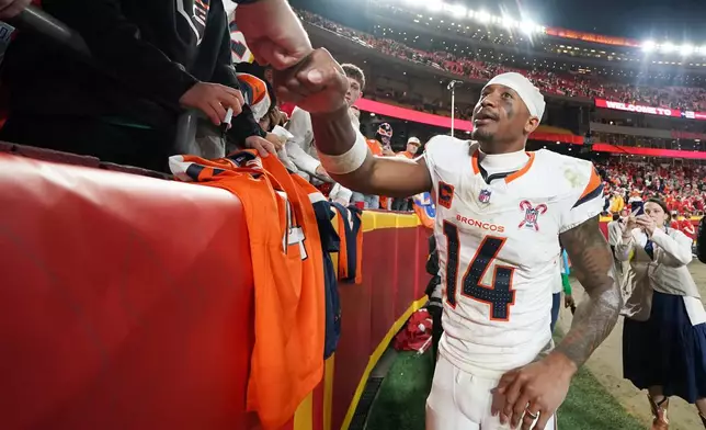 Denver Broncos wide receiver Courtland Sutton talks to supporters following an NFL football game against the Kansas City Chiefs Thursday, Dec. 25, 2025, in Kansas City. (AP Photo/Ed Zurga)