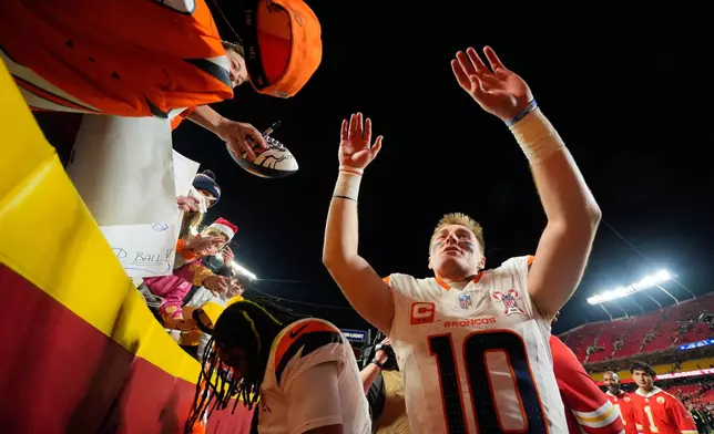 Denver Broncos quarterback Bo Nix acknowledges supporters following an NFL football game against the Kansas City Chiefs Thursday, Dec. 25, 2025, in Kansas City. (AP Photo/Charlie Riedel)