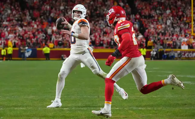Denver Broncos quarterback Bo Nix, left, throws a touchdown pass as Kansas City Chiefs safety Chamarri Conner defends during the second half of an NFL football game Thursday, Dec. 25, 2025, in Kansas City. (AP Photo/Ed Zurga)