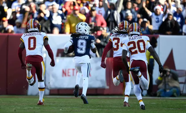 Dallas Cowboys wide receiver Kavontae Turpin (9) heads for the end zone to score on a touchdown pass as Washington Commanders cornerback Mike Sainristil (0), cornerback Antonio Hamilton Sr., and safety Quan Martin (20) give chase during the first half an NFL football game Thursday, Dec. 25, 2025, in Landover, Md. (AP Photo/Nick Wass)