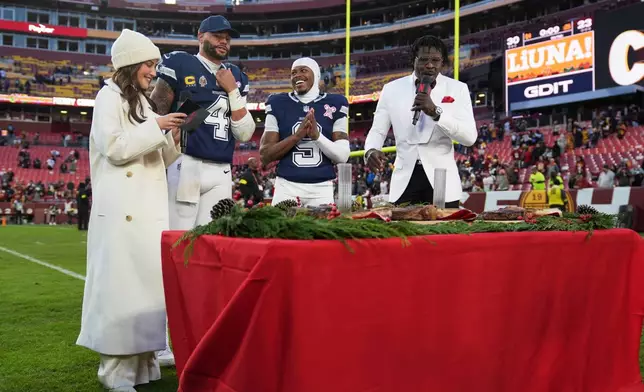 Dallas Cowboys quarterback Dak Prescott (4) and wide receiver Kavontae Turpin (9) are interview by Kay Adams, left, and Michael Irvin, right, following an NFL football game against the Washington Commanders Thursday, Dec. 25, 2025, in Landover, Md. (AP Photo/Stephanie Scarbrough)