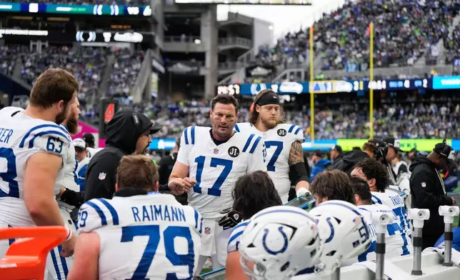 Indianapolis Colts quarterback Philip Rivers (17) talks with teammates during the first half of an NFL football game against the Seattle Seahawks, Sunday, Dec. 14, 2025, in Seattle. (AP Photo/Stephen Brashear)