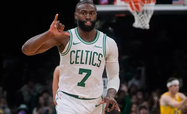 Boston Celtics guard Jaylen Brown celebrates after making a 3-point basket during the second half of an NBA basketball game against the Los Angeles Lakers, Friday, Dec. 5, 2025, in Boston. (AP Photo/Charles Krupa)