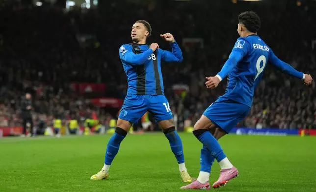 Bournemouth's Marcus Tavernier, left, and Evanilson celebrate a goal during a Premier League soccer match between Manchester United and Bournemouth in Manchester, England, Monday, Dec. 15, 2025. (AP Photo/Jon Super)