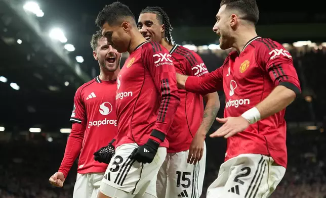 Manchester United players celebrate after a goal during a Premier League soccer match between Manchester United and Bournemouth in Manchester, England, Monday, Dec. 15, 2025. (AP Photo/Jon Super)