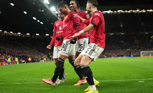 Manchester United players celebrate after a goal during a Premier League soccer match between Manchester United and Bournemouth in Manchester, England, Monday, Dec. 15, 2025. (AP Photo/Jon Super)