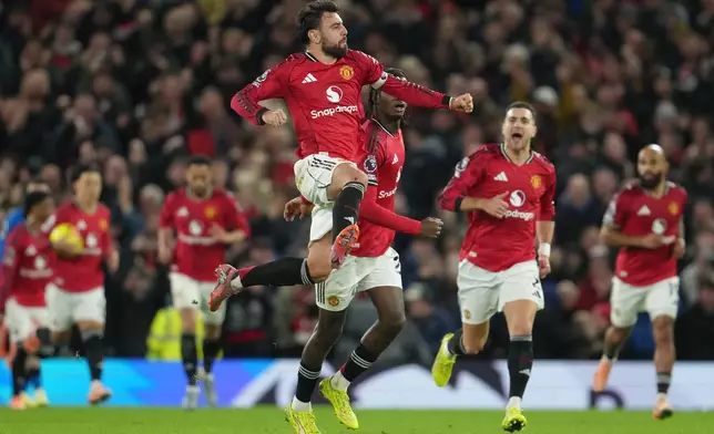Manchester United's Bruno Fernandes celebrates after scoring during a Premier League soccer match between Manchester United and Bournemouth in Manchester, England, Monday, Dec. 15, 2025. (AP Photo/Jon Super)