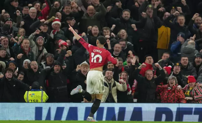 Manchester United's Matheus Cunha celebrates after scoring during a Premier League soccer match between Manchester United and Bournemouth in Manchester, England, Monday, Dec. 15, 2025. (AP Photo/Jon Super)