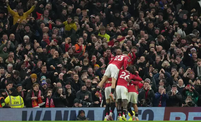 Manchester United players celebrate after a goal during a Premier League soccer match between Manchester United and Bournemouth in Manchester, England, Monday, Dec. 15, 2025. (AP Photo/Jon Super)