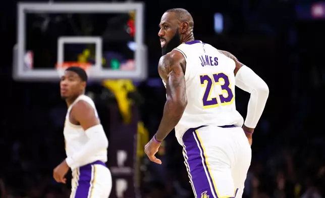 Los Angeles Lakers forward Lebron James (23) reacts after scoring a basket as forward Rui Hachimura, back left, looks onduring the first half of an NBA basketball game against the Sacramento Kings, Sunday, Dec. 28, 2025, in Los Angeles. (AP Photo/Jessie Alcheh)