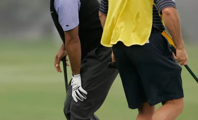 FILE - Tiger Woods holds onto his knee as he comes out of a bunker on the fourth hole during the third round of the US Open championship at Torrey Pines Golf Course, in San Diego, Tuesday June 14, 2008. (AP Photo/Charlie Riedel, File)