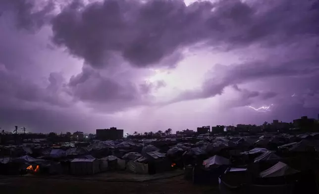 A thunderstorm is seen over a tent camp for displaced Palestinians in Zawaida, central Gaza Strip, Wednesday, Dec. 10, 2025. (AP Photo/Abdel Kareem Hana)