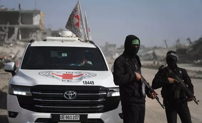 FILE - Hamas militants accompanied by members of the International Committee of the Red Cross (ICRC) head to Zeitoun neighborhood of Gaza City to search for the remains of the final hostage, Dec. 8, 2025. (AP Photo/Jehad Alshrafi, File)
