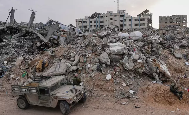 Israeli soldiers gather next to the entrance of a tunnel where the army says the body of soldier Hadar Goldin was held in Rafah, Gaza Strip, Monday, Dec. 8, 2025. Hamas returned his remains to Israel as part of the current ceasefire. (AP Photo/Sam Mednick)
