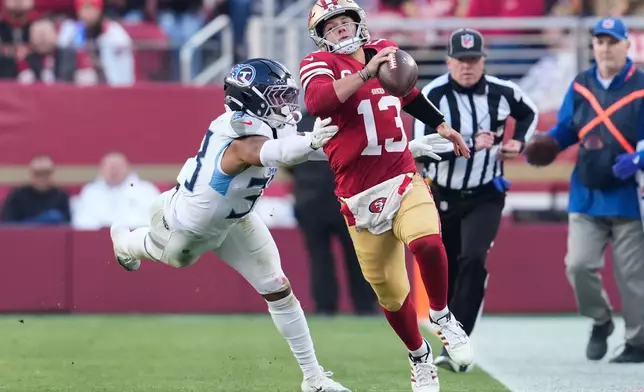 San Francisco 49ers quarterback Brock Purdy (13) runs the ball past Tennessee Titans linebacker Cedric Gray, left, during the second half of an NFL football game, Sunday, Dec. 14, 2025, in Santa Clara, Calif. (AP Photo/Godofredo A. Vásquez)