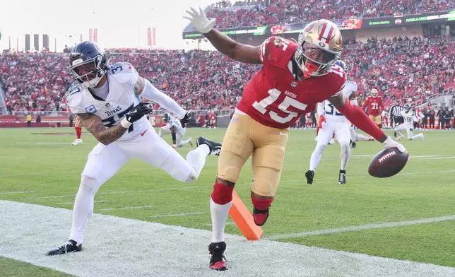 San Francisco 49ers wide receiver Jauan Jennings (15) scores a touchdown past Tennessee Titans safety Amani Hooker (37) during the second half of an NFL football game, Sunday, Dec. 14, 2025, in Santa Clara, Calif. (AP Photo/Jed Jacobsohn)