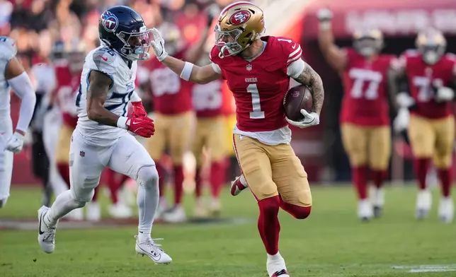 San Francisco 49ers wide receiver Ricky Pearsall (1) gains a first down after a catch past Tennessee Titans cornerback Marcus Harris (26) during the second half of an NFL football game, Sunday, Dec. 14, 2025, in Santa Clara, Calif. (AP Photo/Godofredo A. Vásquez)