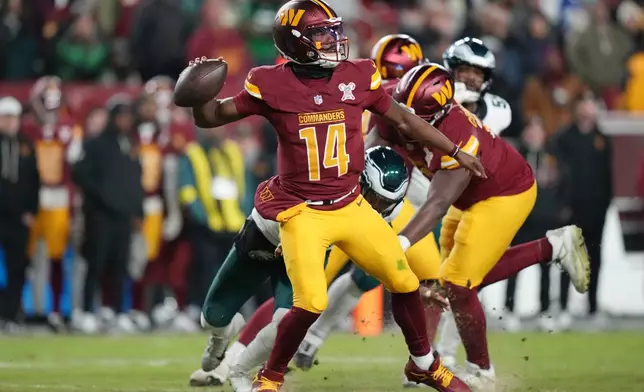 Washington Commanders quarterback Josh Johnson looks to pass the ball against the Philadelphia Eagles during the second half of an NFL football game, Saturday, Dec. 20, 2025, in Landover, Md. (AP Photo/Stephanie Scarbrough)