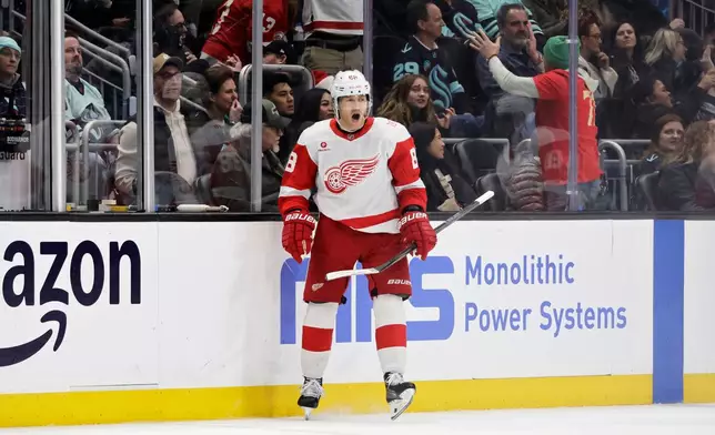 Detroit Red Wings right wing Patrick Kane (88) reacts after scoring against the Seattle Kraken during the third period of an NHL hockey game Saturday, Dec. 6, 2025, in Seattle. (AP Photo/John Froschauer)