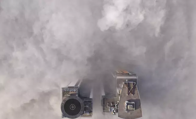 An aerial view of buildings peaking through a dense layer of fog in Sarajevo, Bosnia, Thursday, Dec. 18, 2025. (AP Photo/Armin Durgut)