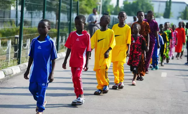 Freed students of St. Mary's Catholic School in the Papiri community upon their arrival at the government house, in Minna, Nigeria, Monday, Dec. 22, 2025. (AP Photo/Sunday Alamba)