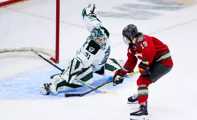 Ottawa Charge's Brianne Jenner (19) scores on Boston Fleet goaltender Aerin Frankel (31) during the first period of an PWHL hockey game in Ottawa, Saturday, Dec. 27, 2025. (Spencer Colby/The Canadian Press via AP)