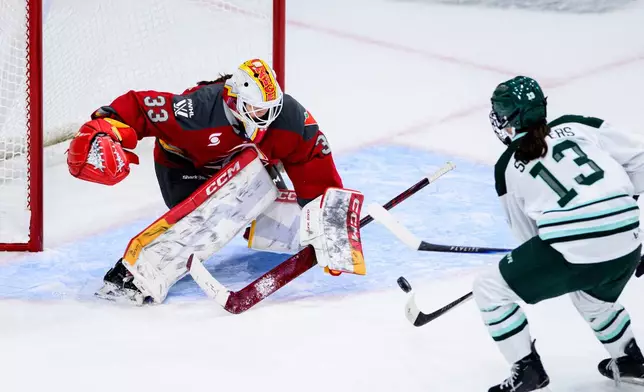 Ottawa Charge goaltender Gwyneth Philips (33) tracks the puck from a shot by Boston Fleet's Lix Schepers (13) during overtime in a PWHL hockey game in Ottawa, Ontario, on Saturday, Dec. 27, 2025. (Spencer Colby/The Canadian Press via AP)