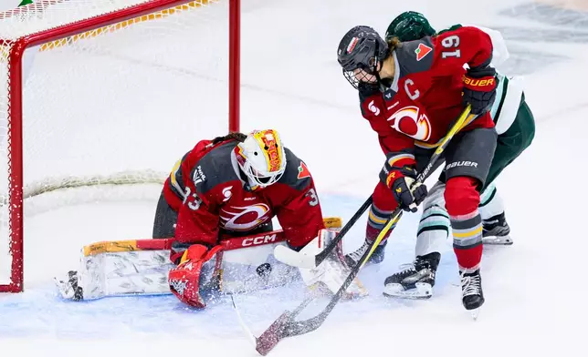 Ottawa Charge goaltender Gwyneth Philips (33) makes a pad save on a shot by Boston Fleet's Theresa Schafzahl (17) during overtime in a PWHL hockey game in Ottawa, Ontario, on Saturday, Dec. 27, 2025. (Spencer Colby/The Canadian Press via AP)