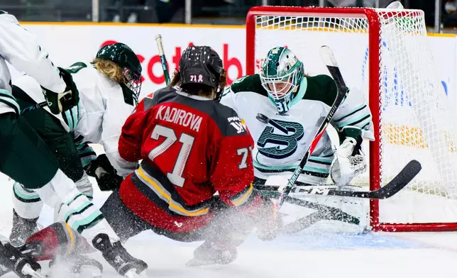 Ottawa Charge's Fanuza Kadirova (71) scores on Boston Fleet goaltender Aerin Frankel (31) during the third period of an PWHL hockey game in Ottawa, Saturday, Dec. 27, 2025. (Spencer Colby/The Canadian Press via AP)